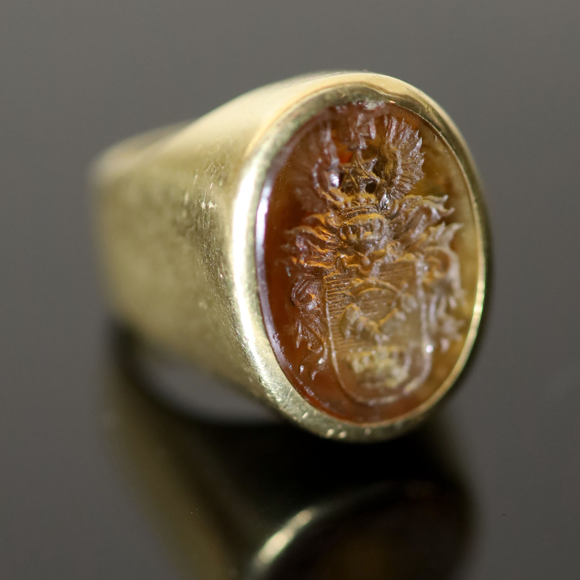 A 20th century continental 18ct gold (stamped 750) and oval citrine? intaglio signet ring,